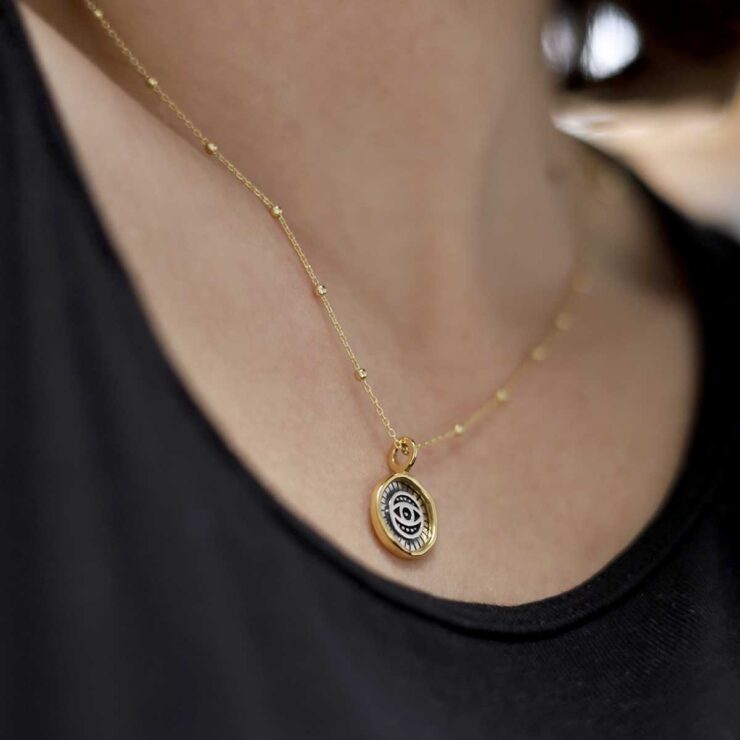 Gold Plated Sterling Silver Evil Eye Round Necklace worn by a model with black tshirt.