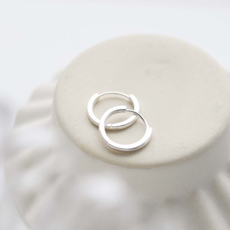 Sterling Silver Flat Huggies in trinket dish